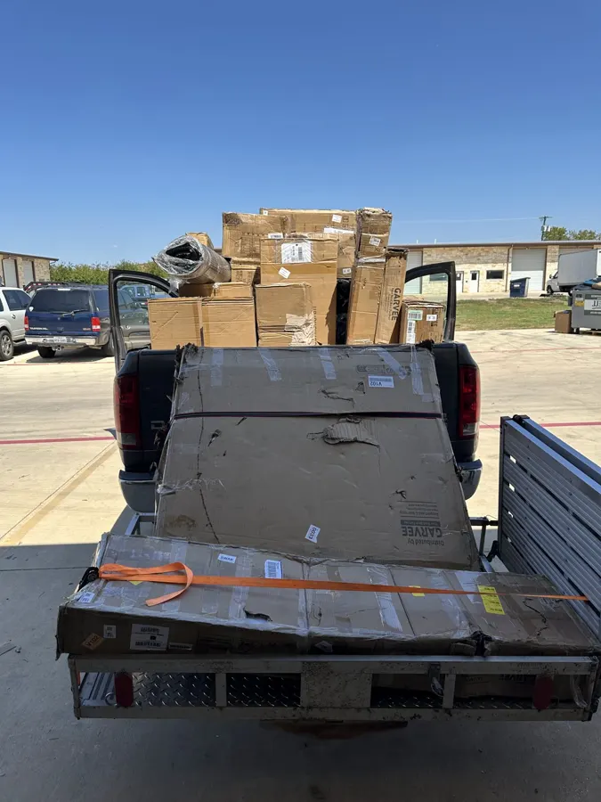 Truck and trailer loaded with large furniture lots